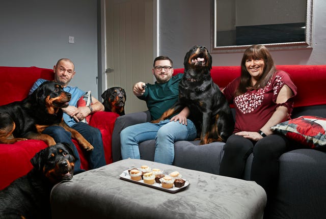 tom, julie and shaun malone sit on the sofa with their dogs in a gogglebox promo photo