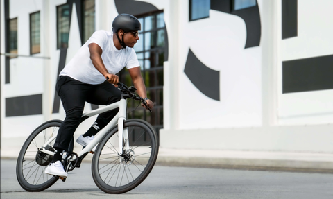 a man riding a white bike