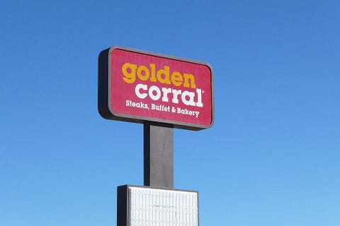 the sign towering over the golden corral parking lot in rock springs, wyoming
