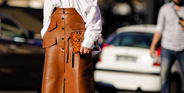 paris, france   september 26  a guest wears a white shirt, a brown leather skirt, brown leather snake print boots, outside rochas, during paris fashion week womenswear springsummer 2019, on september 26, 2018 in paris, france  photo by edward berthelotgetty images