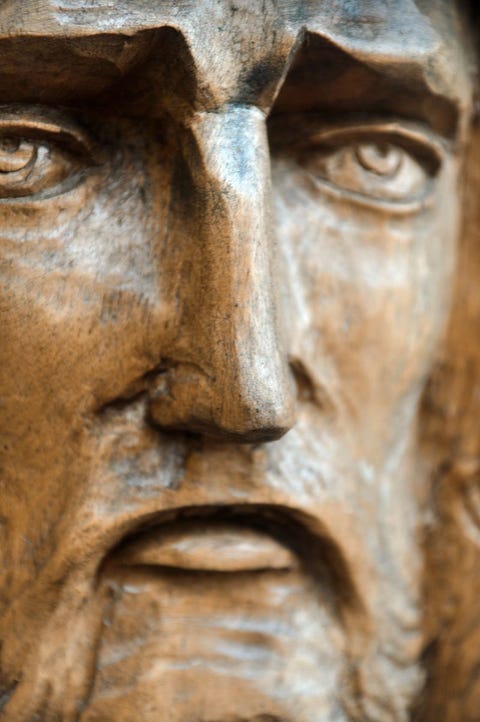close up of wooden jesus face close up of wooden jesus face