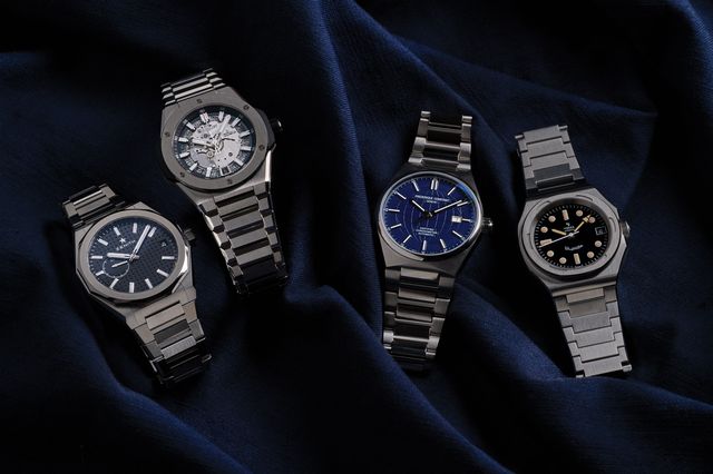 four watches on blue fabric