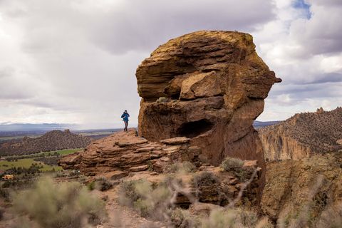 andy cochrane debout à côté d'une formation rocheuse géante