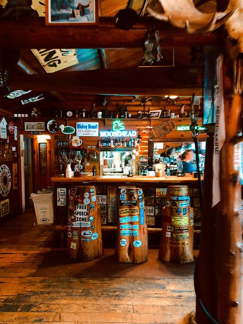 bar covered in wood paneling and bumper stickers at trail center lodge grand marais minnesota