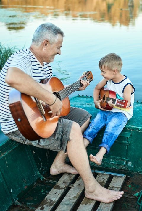 Grandfather teaching grandson playing guitar grandfather teaching grandson playing guitar