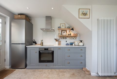 a general interior view of a shaker style kitchen with grey fitted cabinets, units within a home