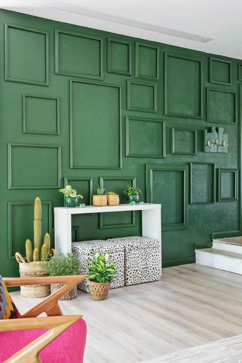 green accent wall with painted frames