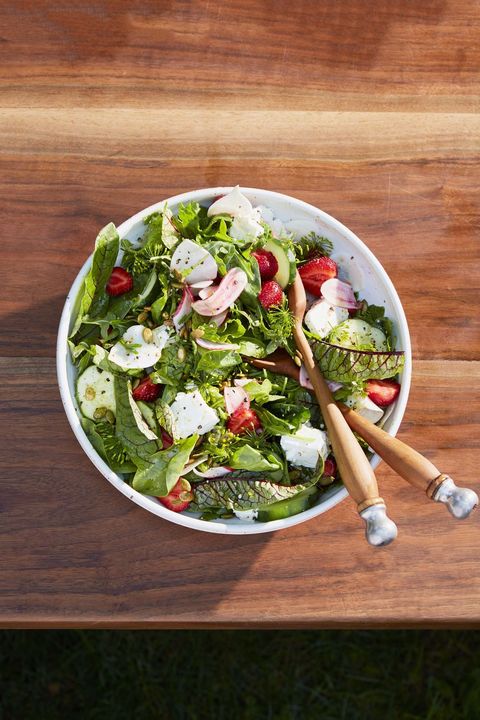 green salad with turnips, strawberries, and pepitas