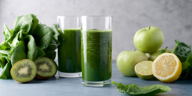 green smoothie in  glass spinach, apple, kiwi, lemon, lime ingredients