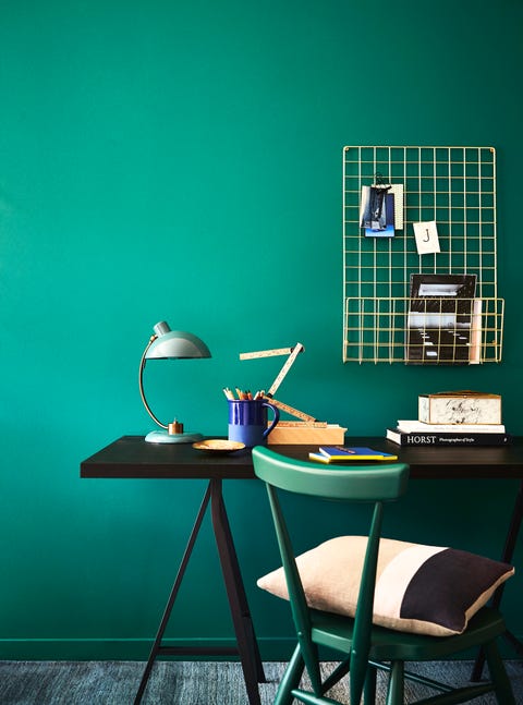 green teal walls behind a desk and a green chair, opulent office, rich teal forms a calming and stylish background to a practical workspace