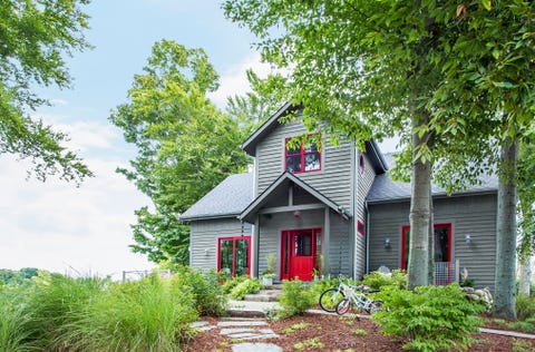 dark gray house with white trim and red door