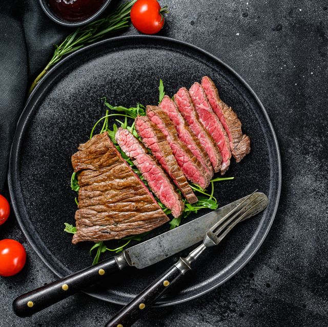 grilled and cut flat iron steak marble beef meat black background top view copy space