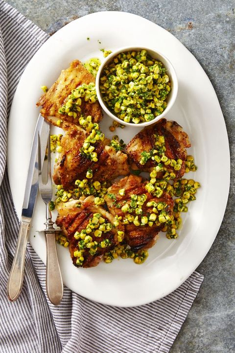 grilled chicken with herbed corn salsa on a white plate