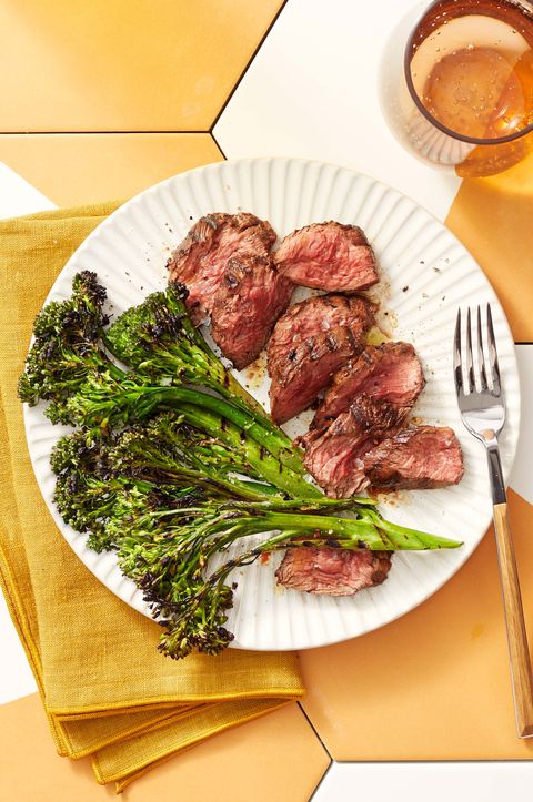 grilled hanger steak with charred broccolini on a plate