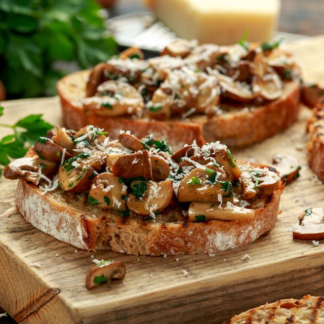 grilled mushroom toast with parsley lemon and parmesan cheese on wooden board healthy vegan food