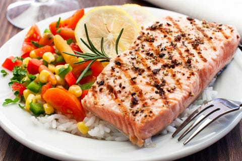 a grilled salmon followed by fresh rice and vegetables
