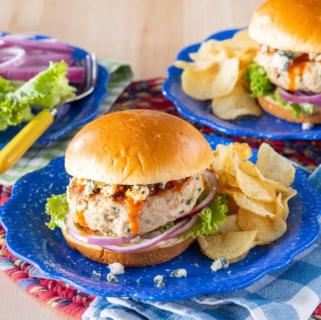 chicken burger on blue plate with potato chips