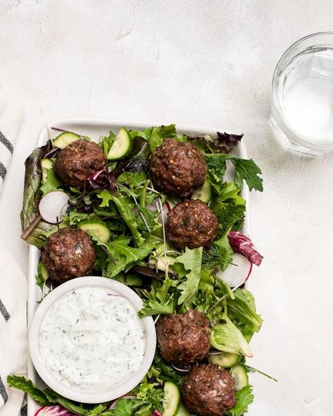 lamb meatballs on salad with dressing on side