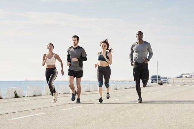 group of sportspeople jogging at harbour