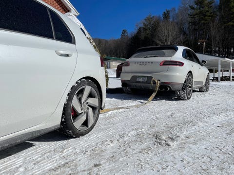 porsche macan towing vw gti out of the snow