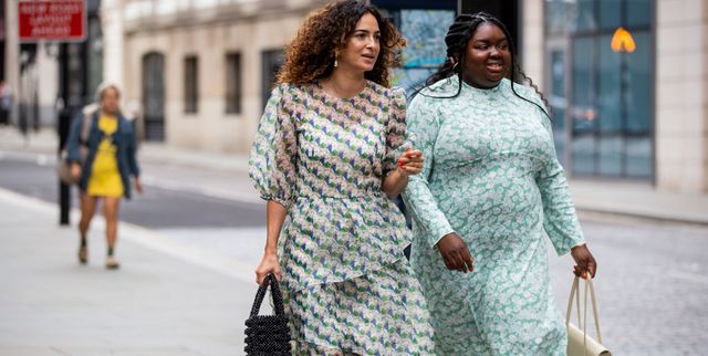 two women at london fashion week wearing rixo dresses and small bags
