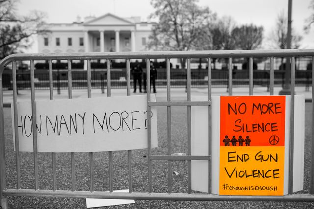 signs outside the supreme court that read how many more and no more silence end gun violence