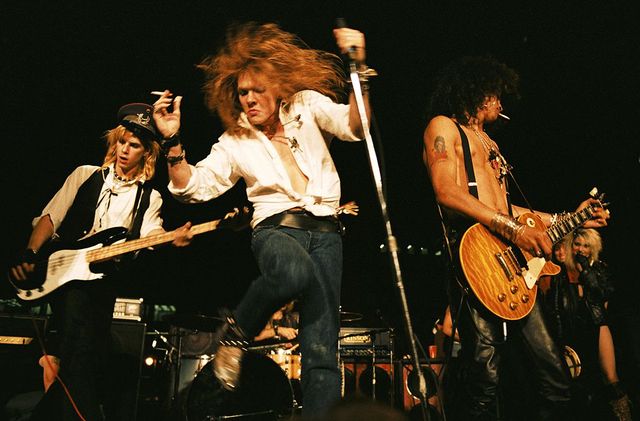 los angeles   september 28  l r duff mckagan, axl rose and slash of the rock group guns n roses perform at the la street scene on september 28, 1985  in los angeles, california slash uses a gibson les paul electric guitar for the first time onstage with the band photo by marc s cantermichael ochs archivesgetty images