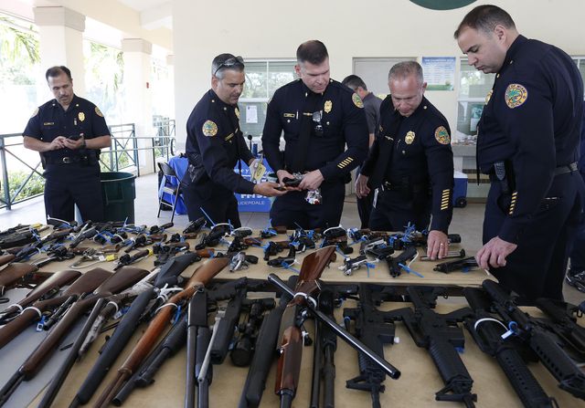 city of miami police review the guns received during a city of miami gun buy back event in miami, florida on march 17, 2018 the city bought over 100 guns, the best ever from a buy back event up to $250 in gift cards was offered in the first of a series of buy backs planned by miami  afp photo  rhona wise        photo credit should read rhona wiseafp via getty images