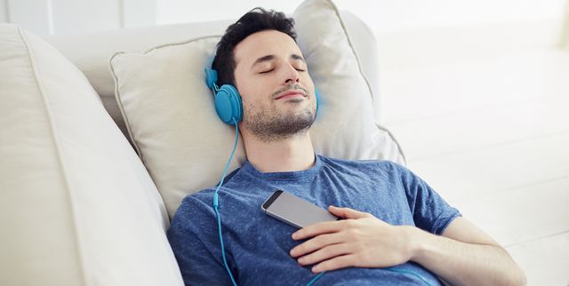 guy with headphones on relaxes listening to music