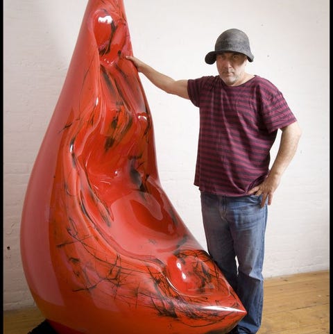 Portrait of Ron Arad with red sculpture