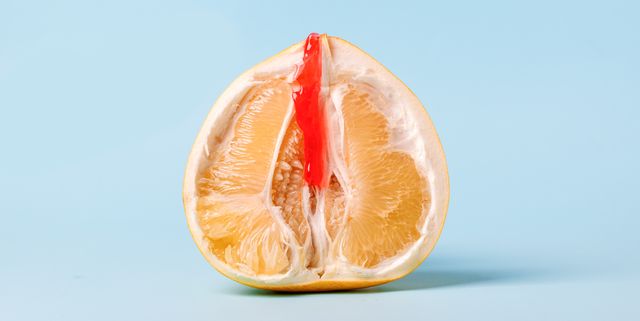 half of pomelo citrus with honey wax red on blue background