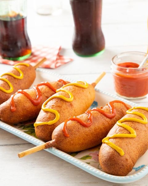 homemade corn dogs with mustard and ketchup drizzle