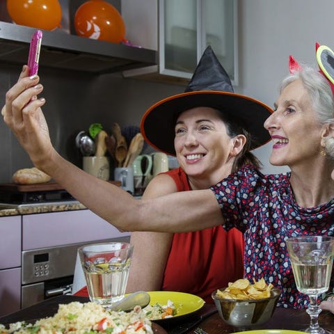 women in halloween costumes taking selfie