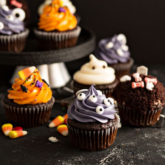 halloween cupcakes with variety of spooky decorations