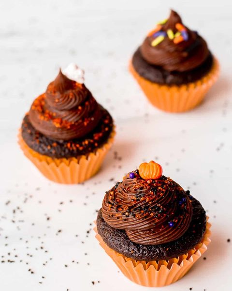mini chocolate halloween cupcakes with orange pumpkin sprinkles and orange liners