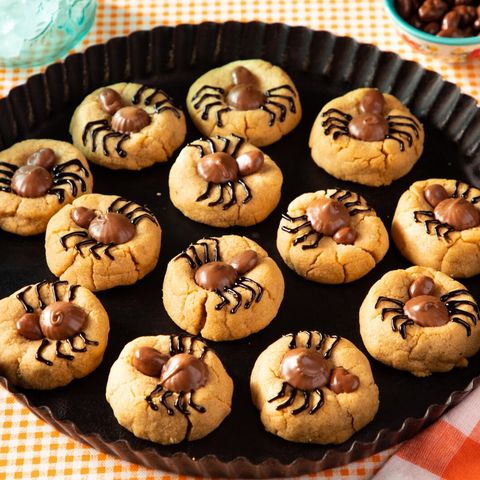 spider cookies on black tray