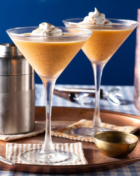 pumpkin pie martini with whipped cream on copper tray