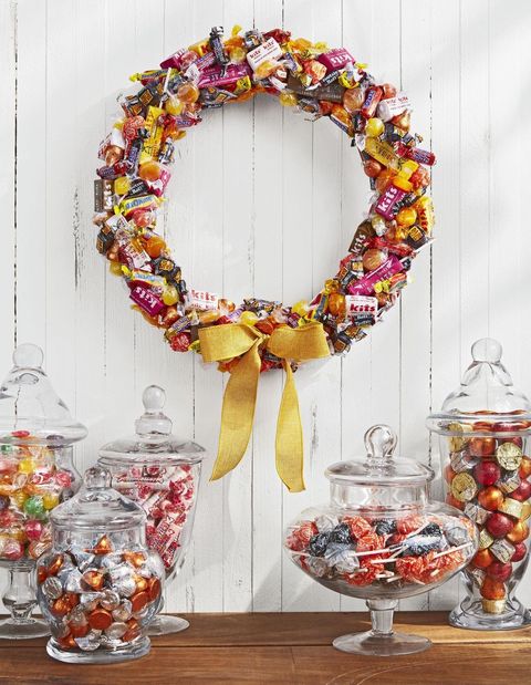 a wreath made of all different types of candy tied with a yellow ribbon