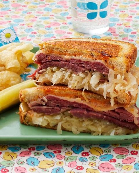 rueben sandwich with pickle and potato chips