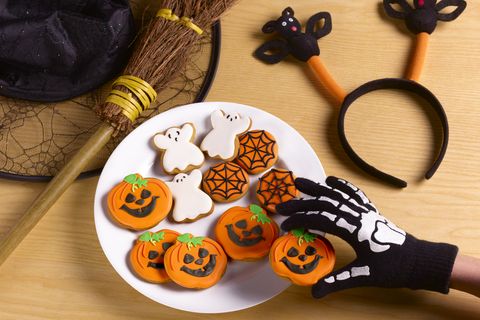 halloween party with witches costume and cookies