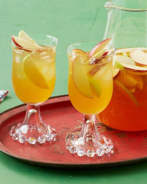 apple cider sangria on red tray and green surface
