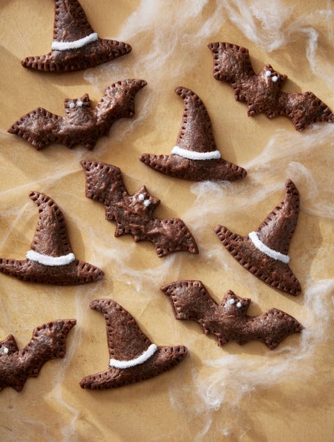 hats and bats chocolate peanut butter tarts arranged on a tan sheet of parchment