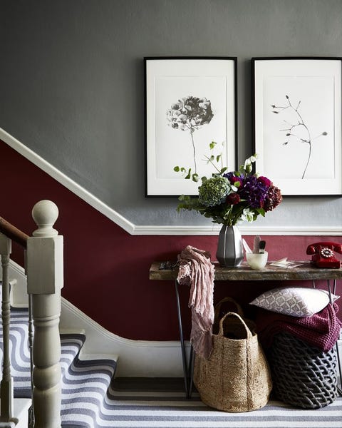 hallway with striped staircase and red paint