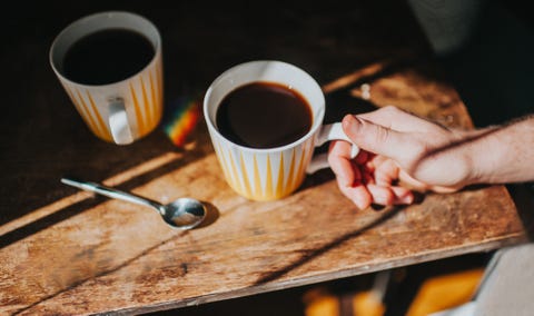 hand holding a coffee cup