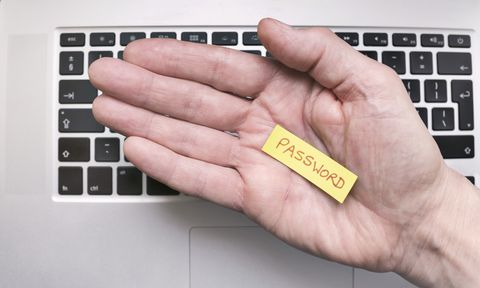 Hand holding note saying Password