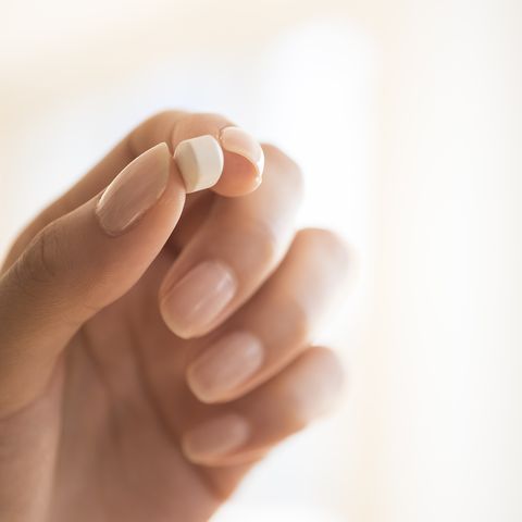 Hand holding vitamin pill