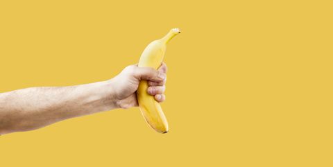 Hand male holding a shape banana telephone.