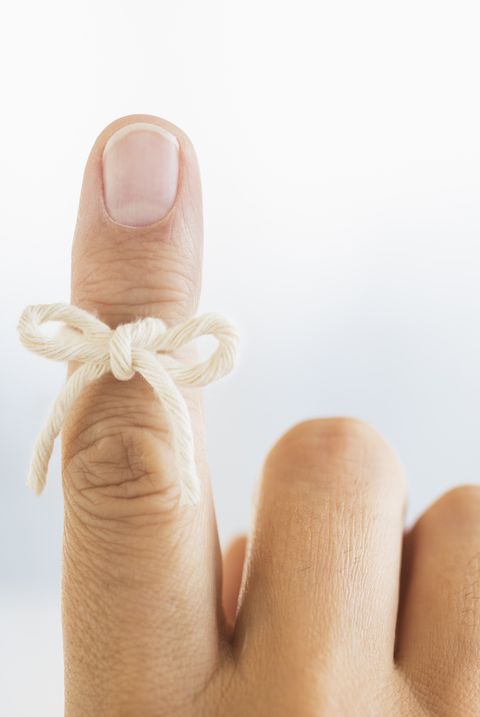 Hand with reminder bow on finger