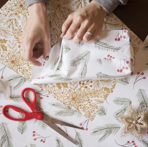 Hands of Caucasian woman wrapping Christmas gifts