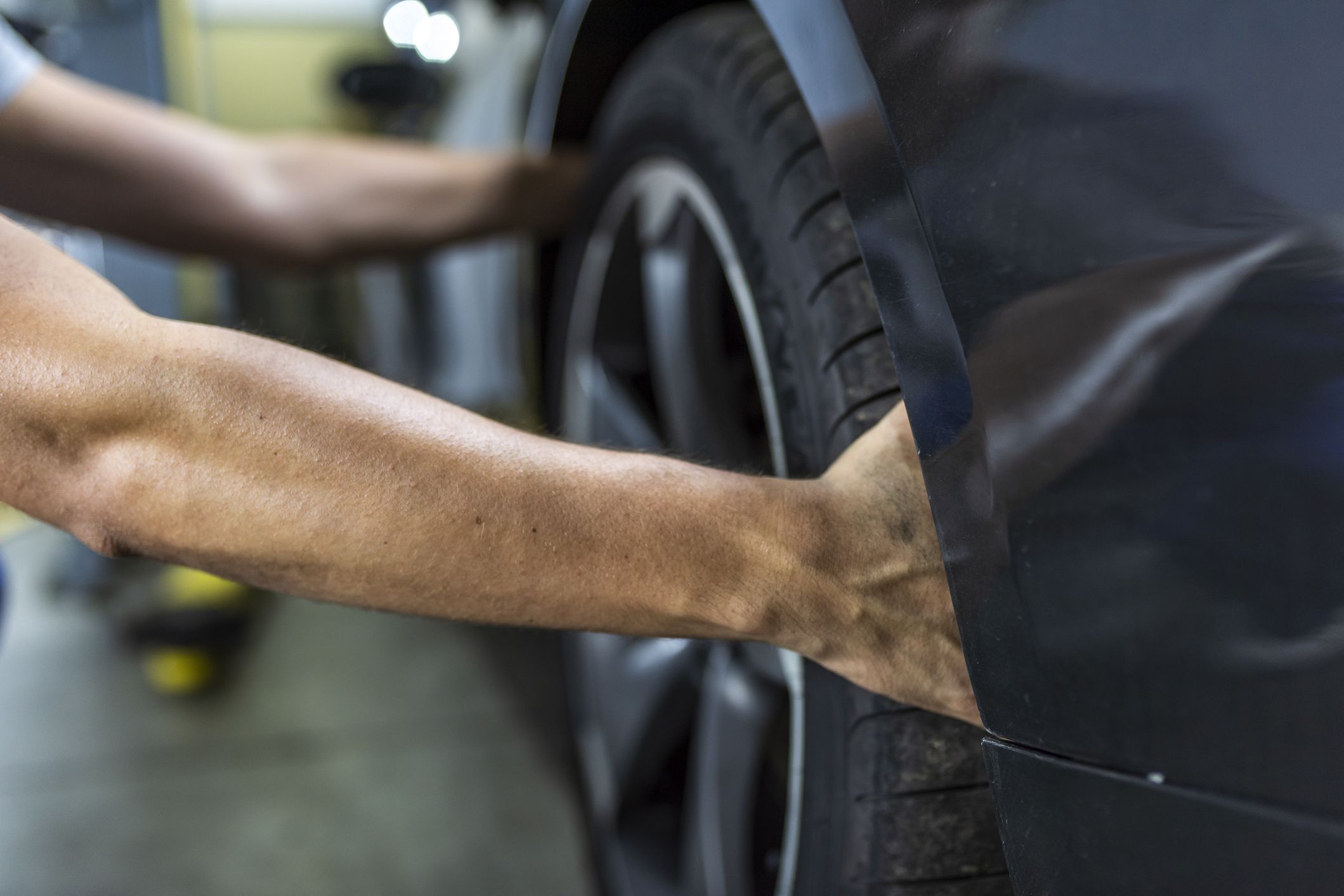 hands of mechanic changing a wheel of a modern car royalty free image 1601910566